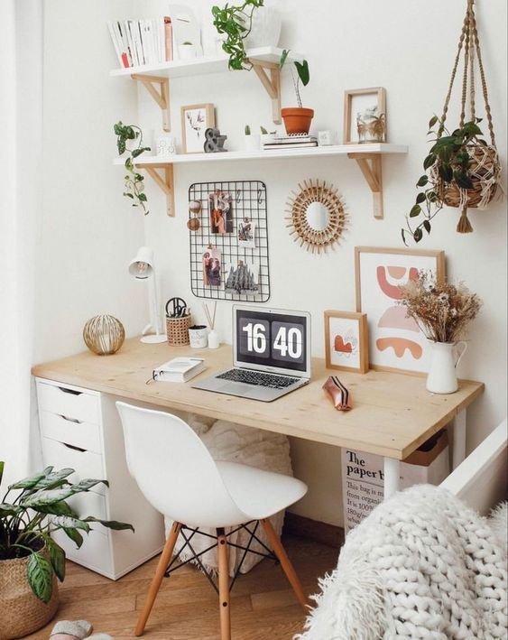 Home office em tons claros com mural e plantas